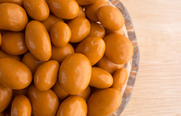Caramel coated raisins in bowl on tabletop