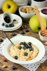Oatmeal porridge with berries, nuts and honey