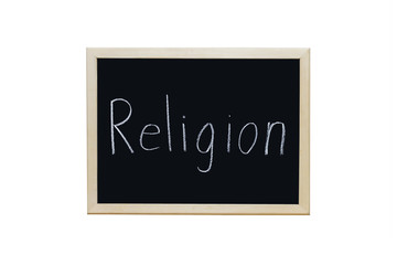 Religion written with white chalk on blackboard.