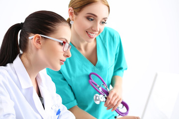 Two female doctors looking at monitor