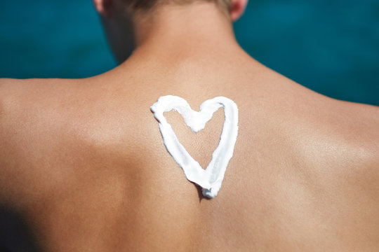 Suntan Lotion At The Beach In Form Of The heart
