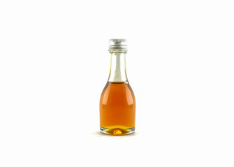 Honey in a glass bottle isolated on white background