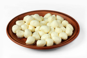 Baby mozzarella on a plate isolated on white background