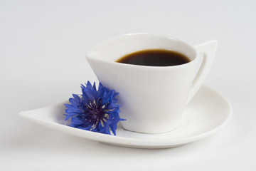 coffee cup with blue flower on white stone table