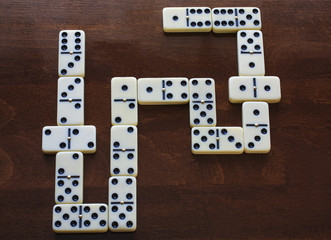 domino pieces on the brown wooden table background