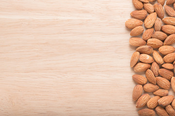 Almonds on wooden background