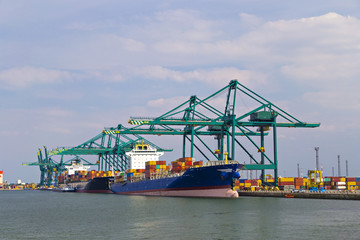 Huge container ship loaded with cranes in Antwerp container terminal