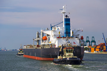 Container ship leaving the container terminal in Port of Antwerp, Belgium