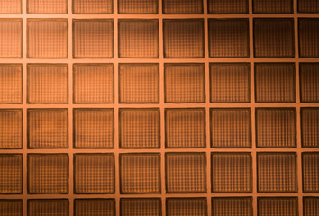 orange glass block wall background with lighting from corner