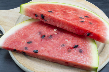 Sliced fresh watermelon on a wooden tray