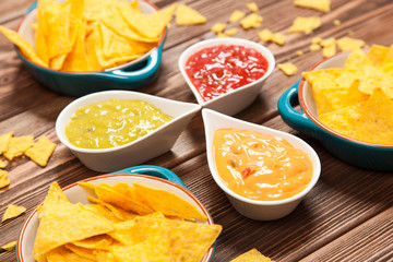 Plate of nachos with different dips