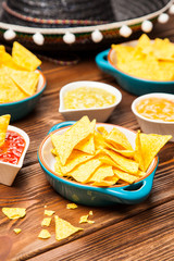 Plate of nachos with different dips