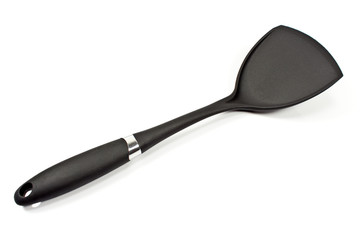 Black plastic kitchen spatula isolated on white