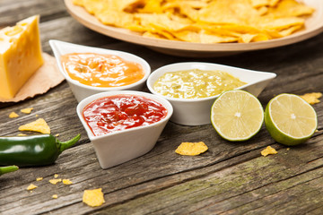 Plate of nachos with different dips