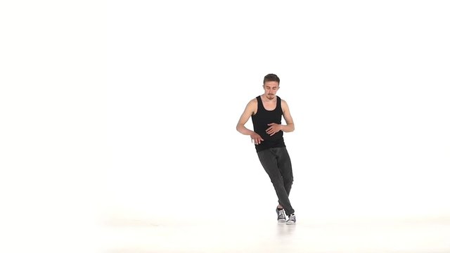 Young b-boy man in shirt doing brake dancing movements, on white