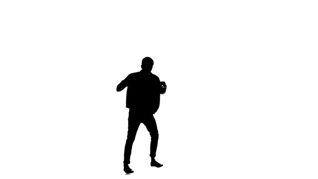 Young, stylish b-boy man in shirt doing brake dancing movements