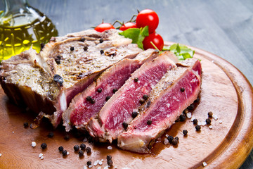 grilled sliced meat fillet on wooden background