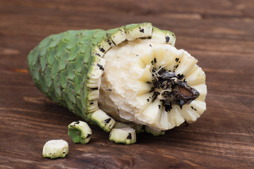 Exotic fruit monstera deliciosa on a wooden background, popular fruit on Madeira island