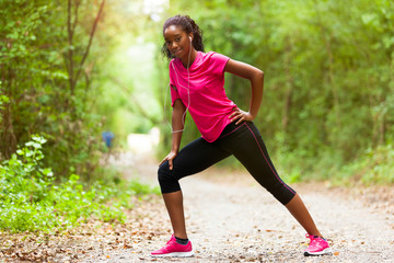  African american woman jogger stretching  - Fitness, people and