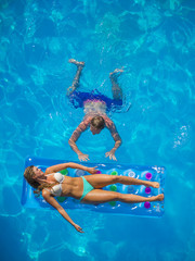 Couple Outside Relaxing In Swimming Pool