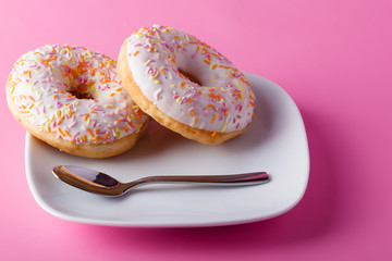 Colorful donut on pink background