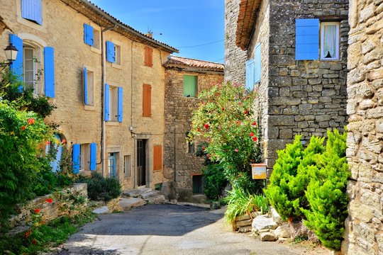 Fototapeta Pretty houses with colorful shuttered windows in a quaint village in Provence, France