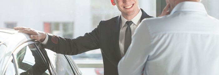 Smiling man by the car