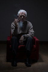 Senior man smoking cigarette