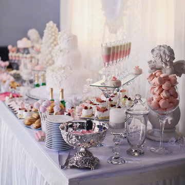 Dessert table for a party. Ombre cake, cupcakes, sweetness and f