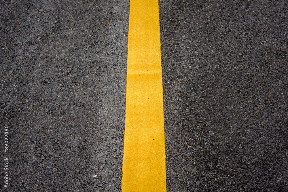 Wall mural yellow line on the road texture