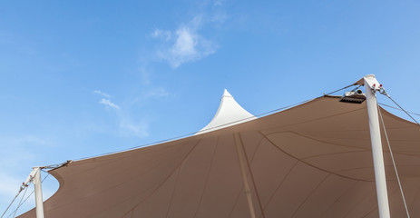 Looking up at the top of white tent against clear blue sky backg © mrcmos