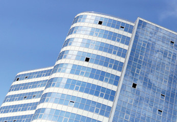 Fototapeta premium Exterior of high office building against blue sky