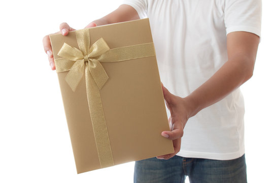 man in white t-shirt  holding  golden gift box