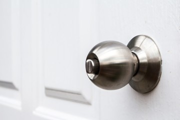 Aluminium door knob on the white door skin