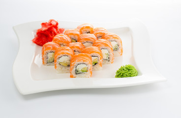 Philadelphia salmon sushi roll on a plate over wooden background