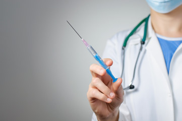 Female doctor with syringe