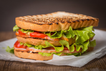 Classic club sandwich with bacon and vegetables