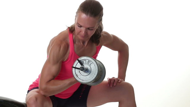 Woman performing bicep curl exercise. Studio shot over white.
