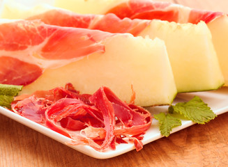 sweet melon with serrano ham cut on chips and sliced