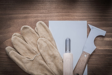 Putty knife plastering trowel and leather working gloves