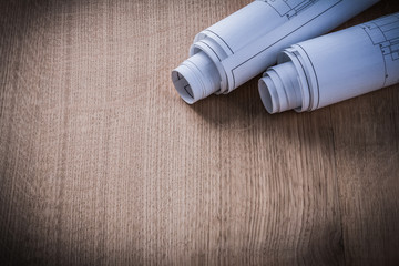 Rolled construction drawings on wood board architecture and buil