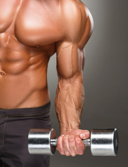 Closeup of a handsome power athletic man bodybuilder doing