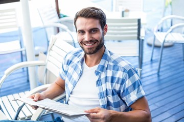 Young man reading the newspapers