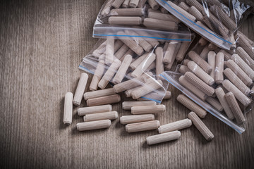 Wooden dowel pins on wood board horizontal version construction 