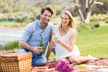 Cute couple on date pouring wine in a glass