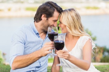Cute couple on date holding red wine glasses