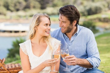 Couple toasting with glass of white wine