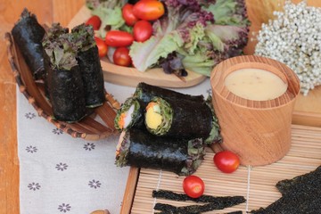 Vegetable salad wrapped with seaweed into spring rolls.