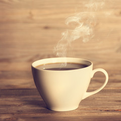 Steaming hot coffee in white cup