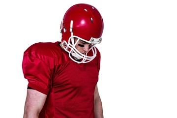 Unsmiling american football player looking down